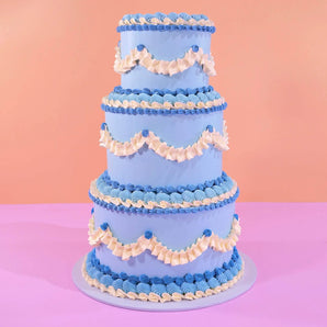 3 Tier Vintage Cake by Crumbs & Doilies with blue and white piped Swiss Meringue decoration on three tiers